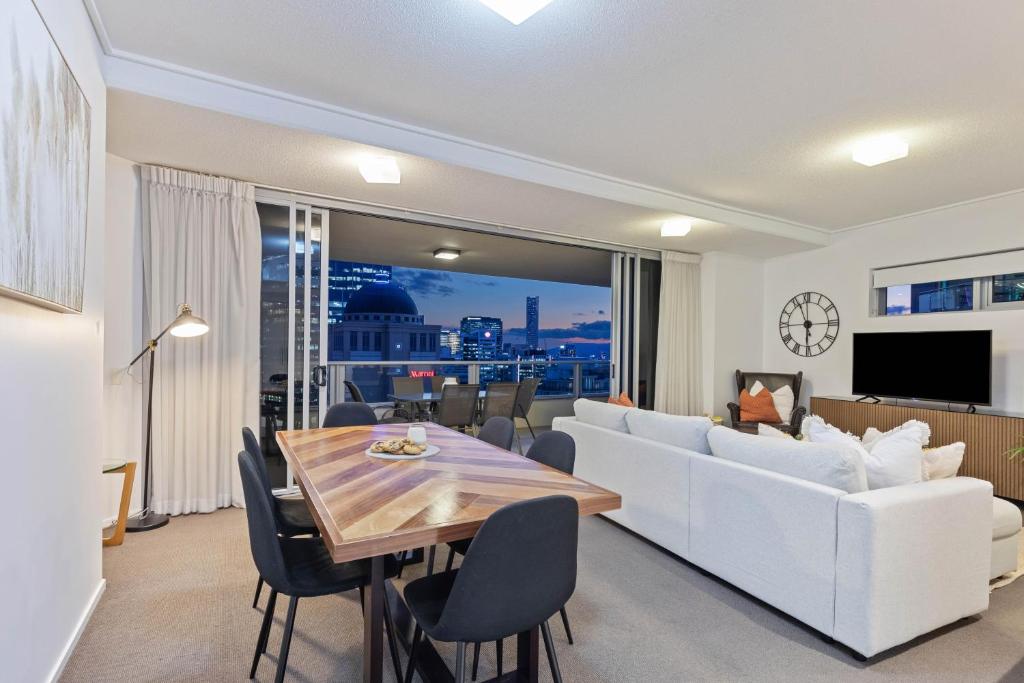 a living room with a white couch and a table at AAB Apartments Skyline in Brisbane