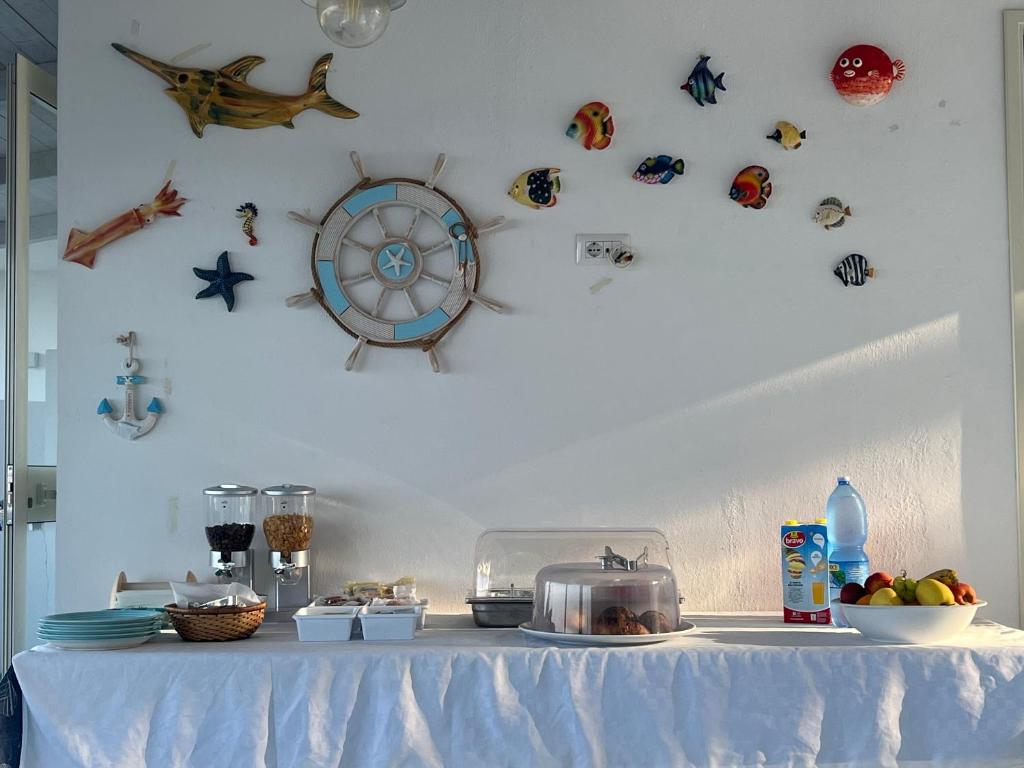 a table with a white table cloth and some items on it at Miriasol Bed and Breakfast in Capo Vaticano