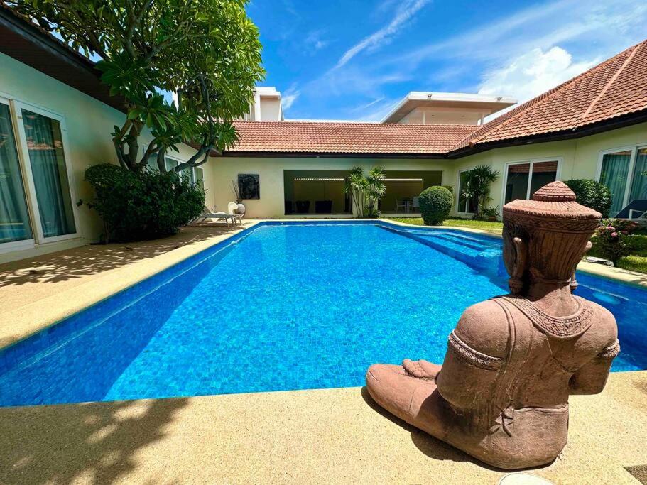 a swimming pool in front of a house at View Talay Villas - Huge Luxury Pool Villa - 500m from Jomtien beach - 188 - old in Jomtien Beach