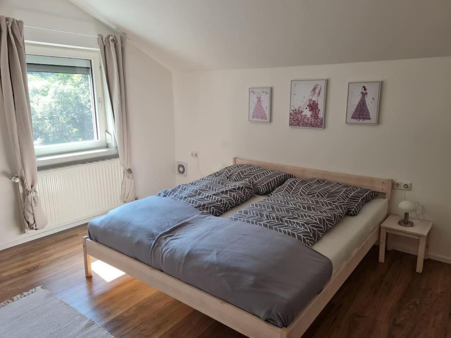 a bed sitting in a bedroom with a window at StayEasy Apartments Ramingtal #1 