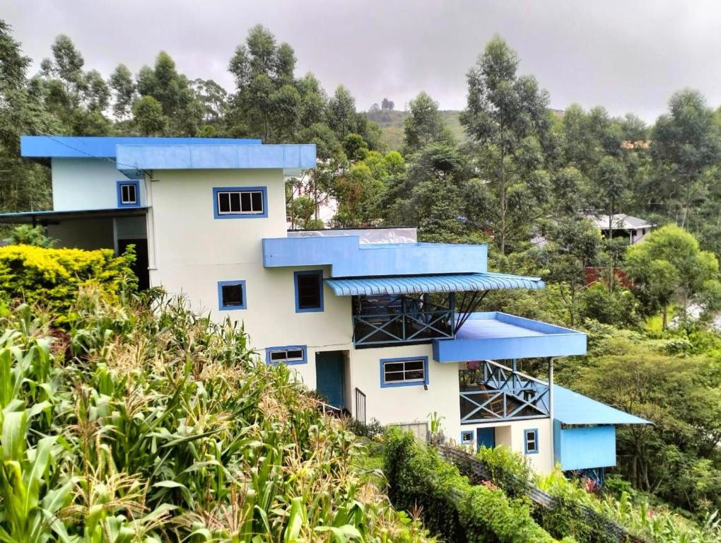 a house on a hill with blue roofs at Kou Pusan Home Kundasang in Kundasang