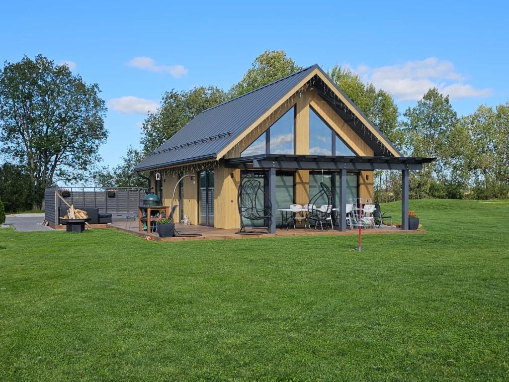 a large gazebo in a field of grass at Tartu Pajuoja saunamaja in Tartu