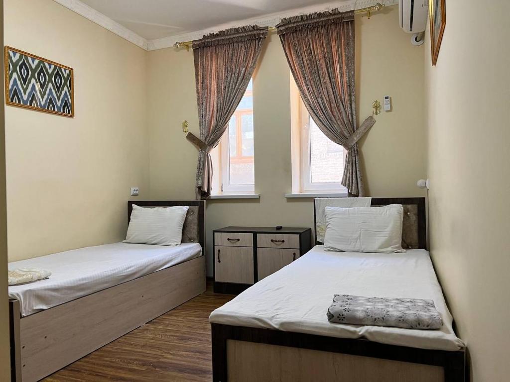 מיטה או מיטות בחדר ב-Ikat Terrace
