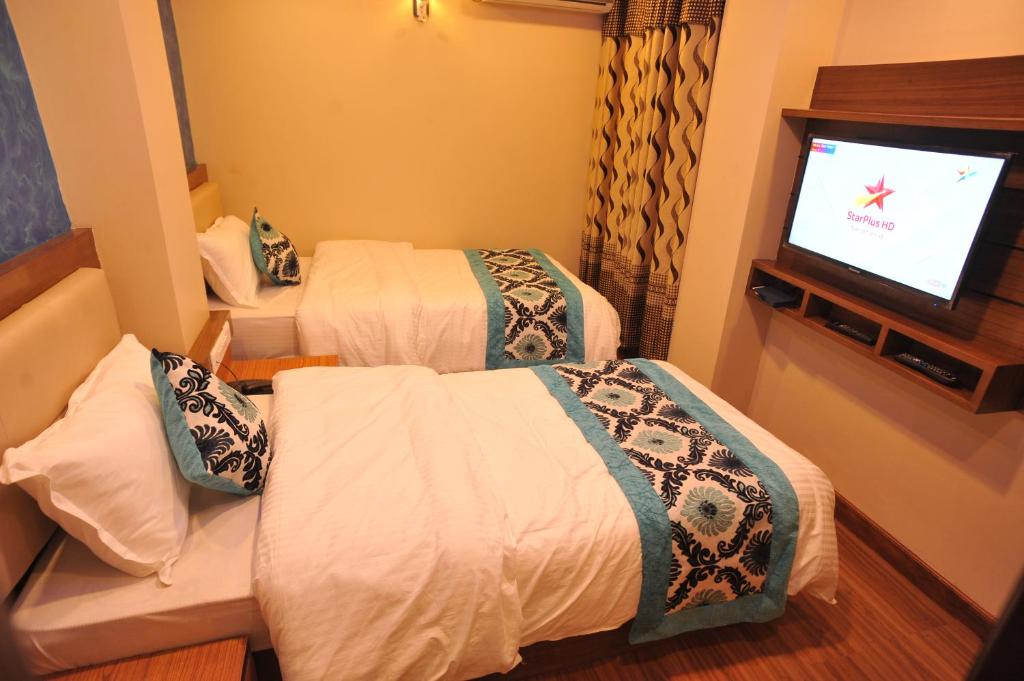 Postel nebo postele na pokoji v ubytování Hotel Arati Pvt. Ltd.