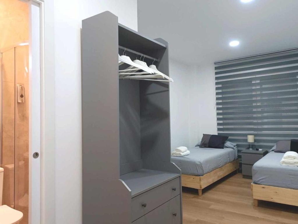 A bed or beds in a room at Casa de Huéspedes 12 Octubre Rooms