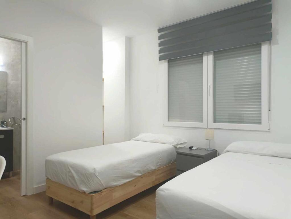 A bed or beds in a room at Casa de Huéspedes 12 Octubre Rooms