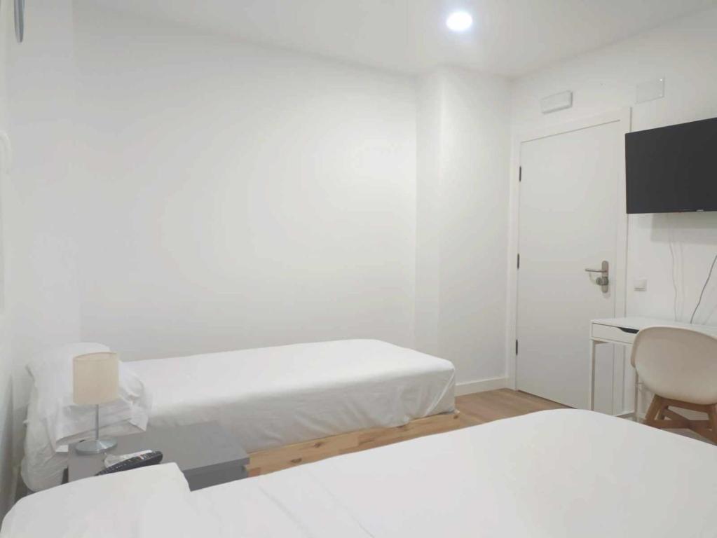 A bed or beds in a room at Casa de Huéspedes 12 Octubre Rooms