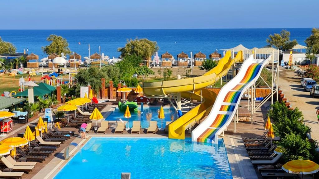 a pool with a water slide at a resort at Unluselek Hotel in Anamur