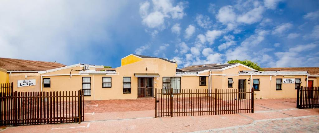 a building with a fence in front of it at Oria Lodge in Cape Town