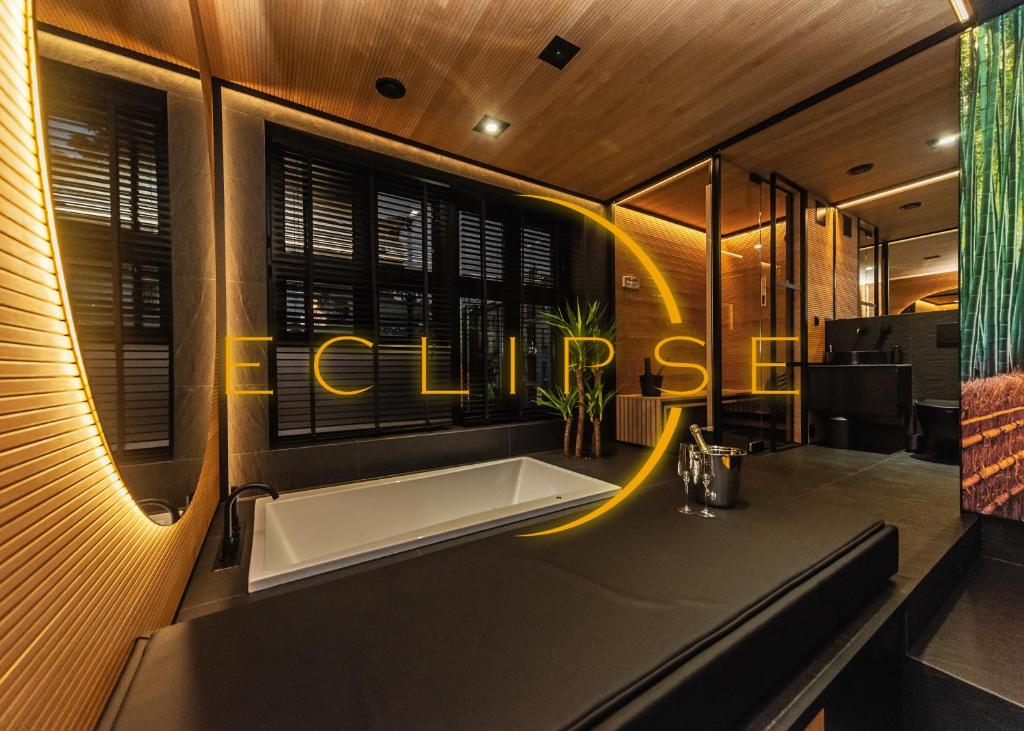 a bathroom with a tub and a sign that reads chill out at Eclipse Gold Room in Bielsko-Biała