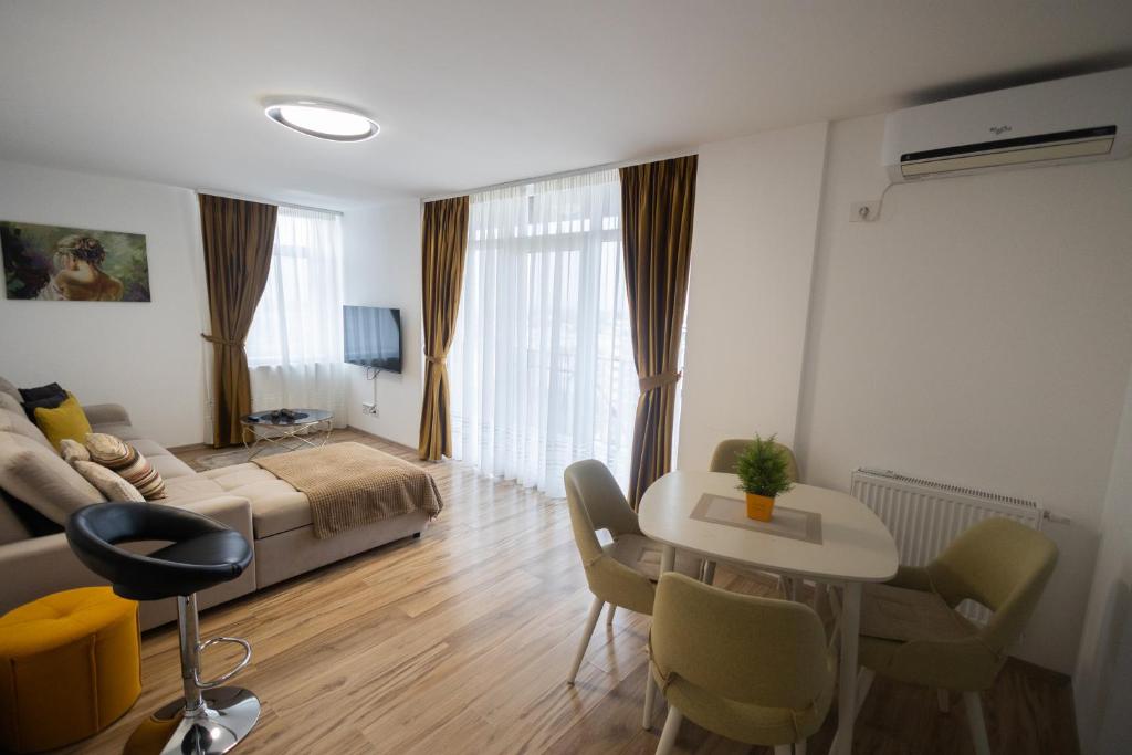 a living room with a couch and a table at Panorama Luxury Apartment in Oradea