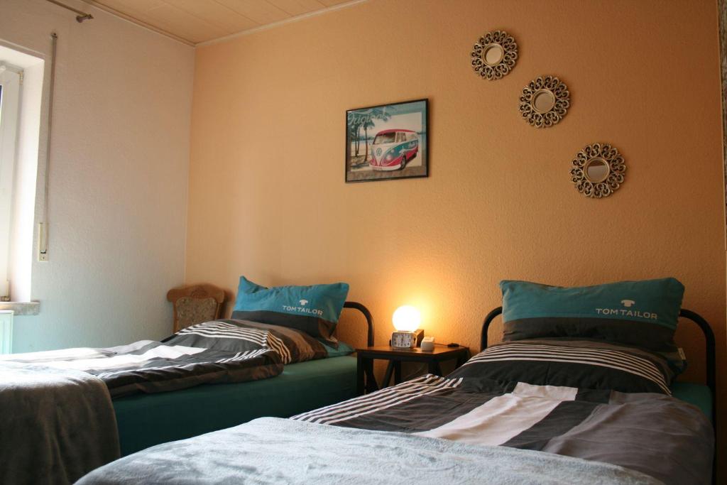 a bedroom with two beds and a table with a lamp at Your Work & Stay Home in Mechernich in Mechernich