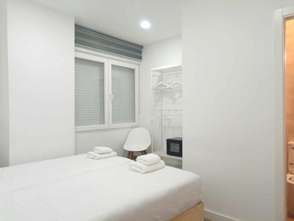 A bed or beds in a room at Casa de Huéspedes 12 Octubre Rooms