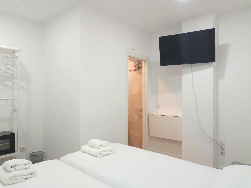 A bed or beds in a room at Casa de Huéspedes 12 Octubre Rooms