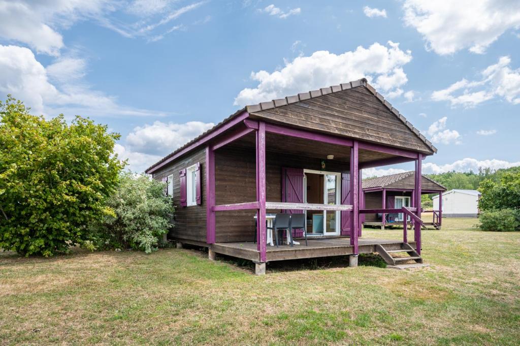 a purple tiny house on a grass field at Camping Les Vosges du Nord in Oberbronn