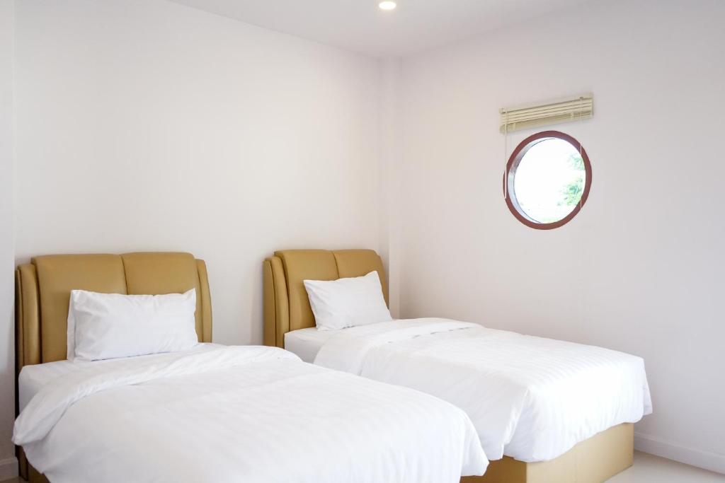 Postel nebo postele na pokoji v ubytování Chanmuang Resort ชานเมืองรีสอร์ท