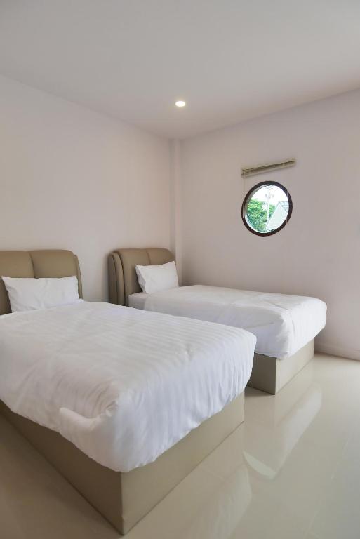Postel nebo postele na pokoji v ubytování Chanmuang Resort ชานเมืองรีสอร์ท