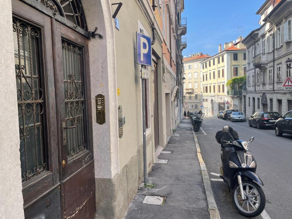 a scooter parked on the side of a street at Residence Nove in Trieste