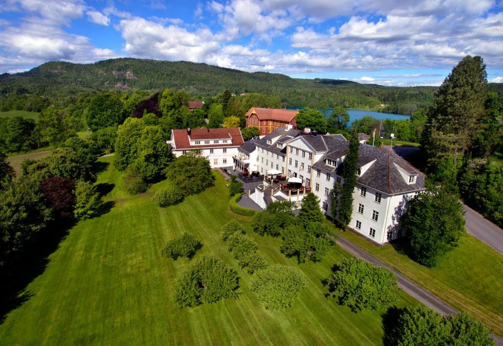 an aerial view of a large house on a green field at Øvre Sem Gård in Asker