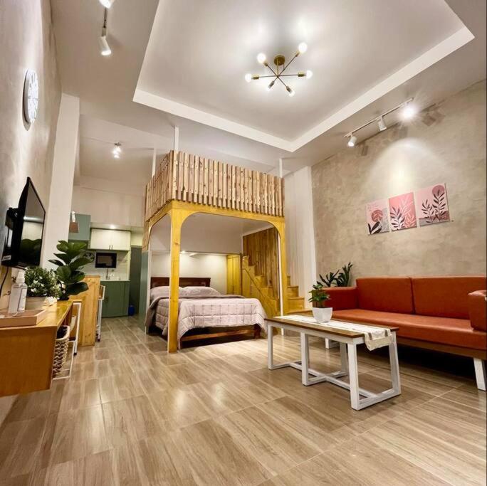 a living room with a bed and a couch in a room at JORA LOFT - Japandi inspired apt 1- D in Dagupan