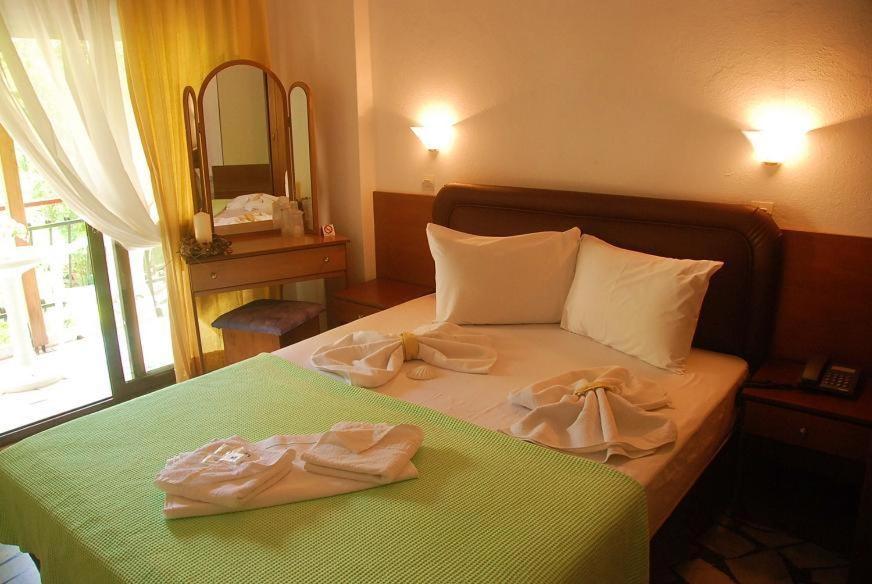 Postel nebo postele na pokoji v ubytování Orpheus Hotel