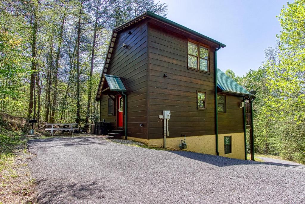 a small house with a red door on a road at Always Misbehavin #1412 in Gatlinburg