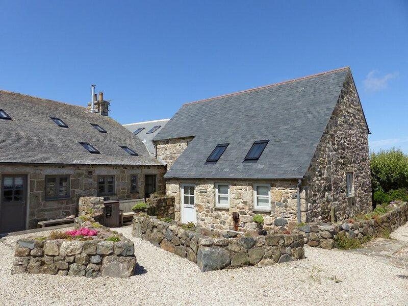 a stone house with windows and a stone wall at Rosewall in St Ives