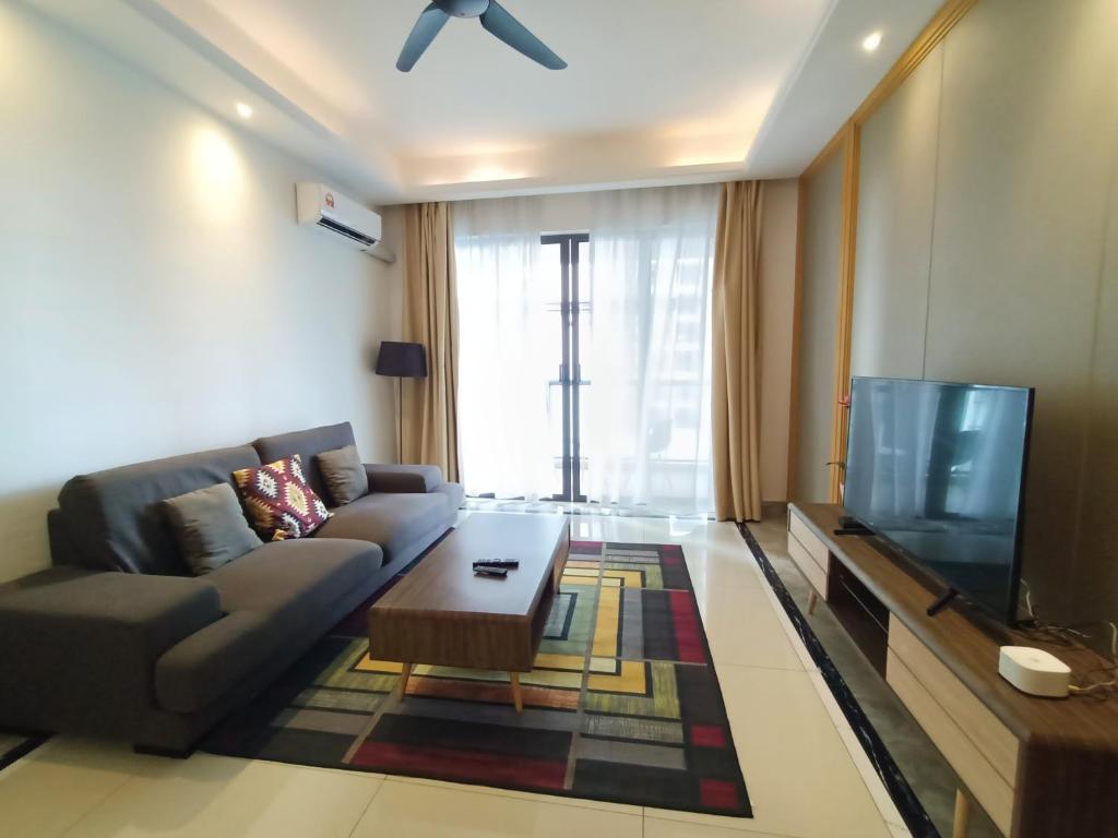 - un salon avec un canapé et une télévision dans l'établissement R&F princess cove family premium suites, à Johor Bahru