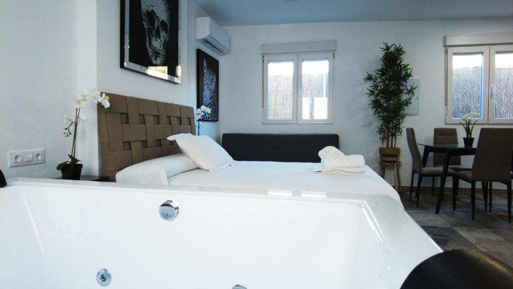 a room with a large white tub in a room at SUITE ORQUIDEA in Benalup Casas Viejas