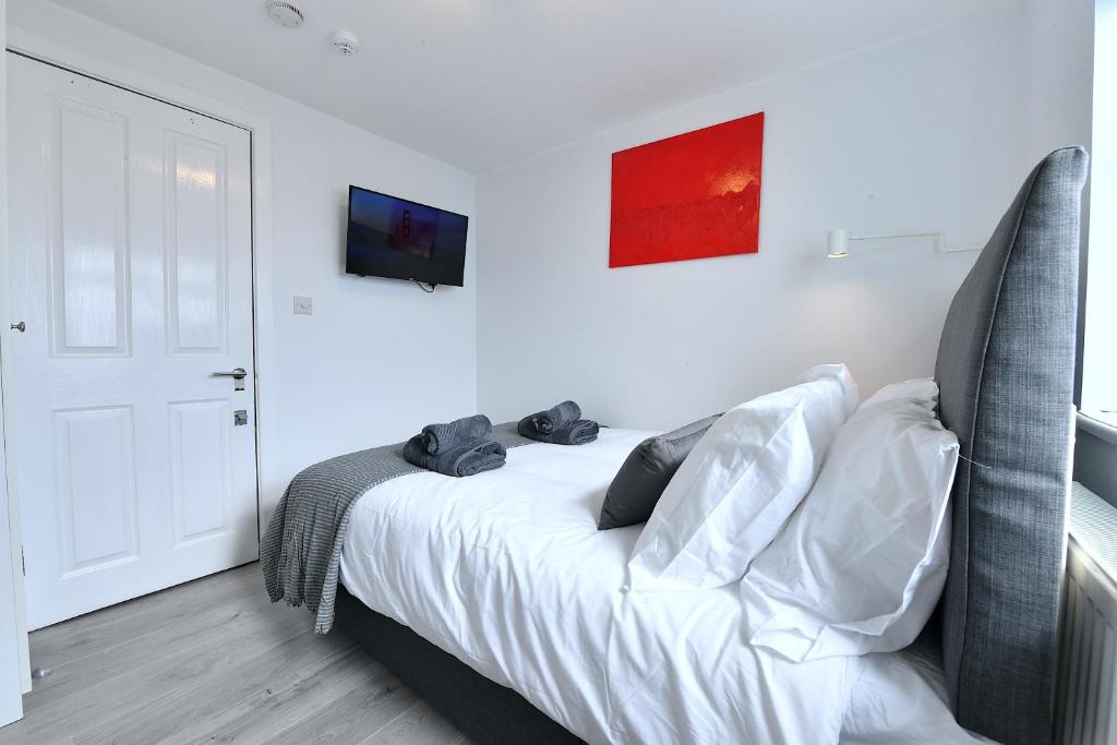 a bedroom with a bed and a tv on the wall at Stylish Studios by Luxestays Fulham in London