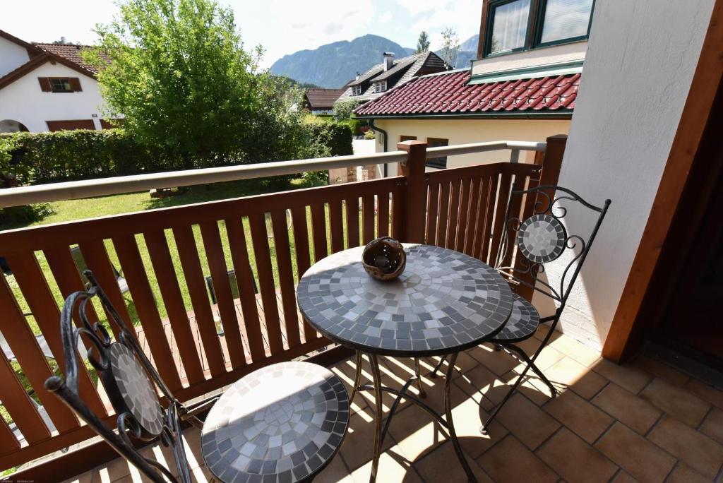 a cat sitting on a table on a balcony at Haus Redtenbacher in Windischgarsten