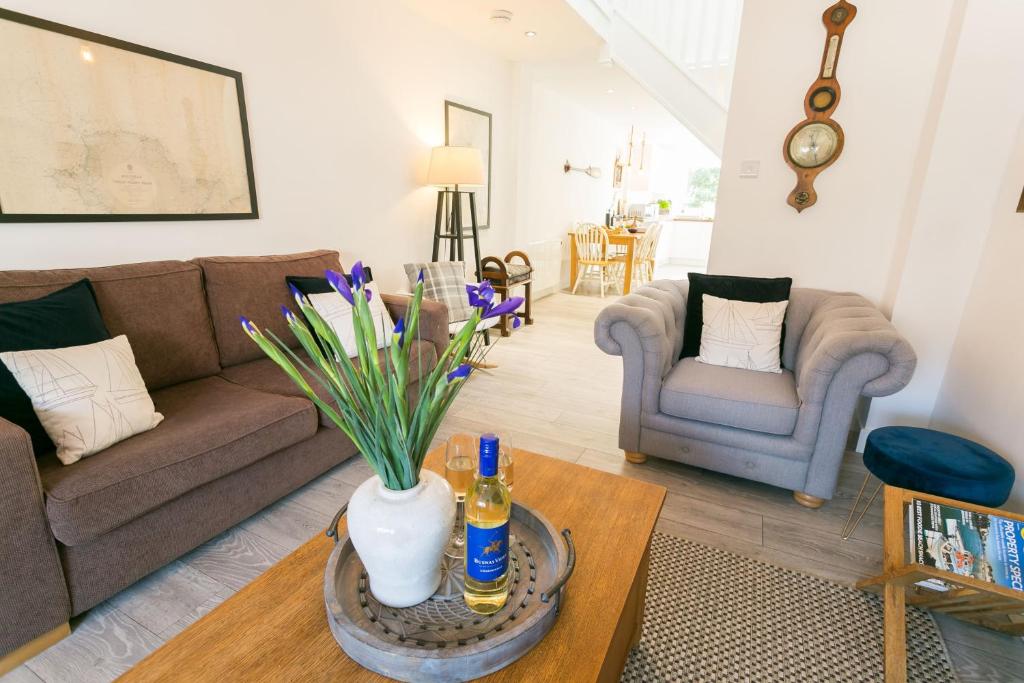 a living room with a couch and a table at Anchor Cottage in Cemaes Bay