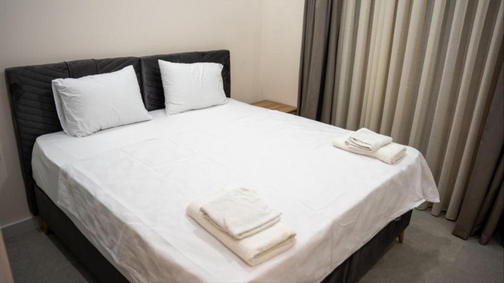 a bedroom with a bed with two towels on it at AMY VILLAS in Antalya