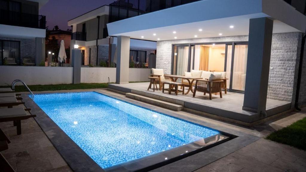 a swimming pool in the backyard of a house at AMY VILLAS in Kemer