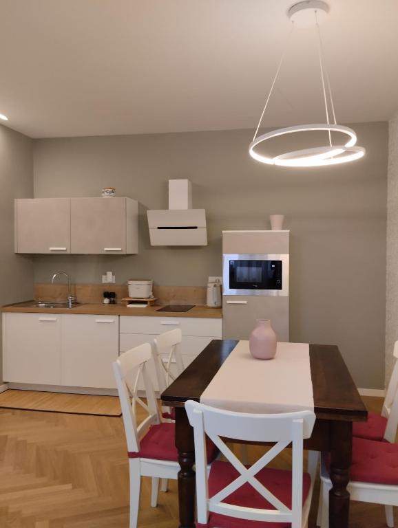 a kitchen with a table and chairs in a room at La Morra 66 in La Morra