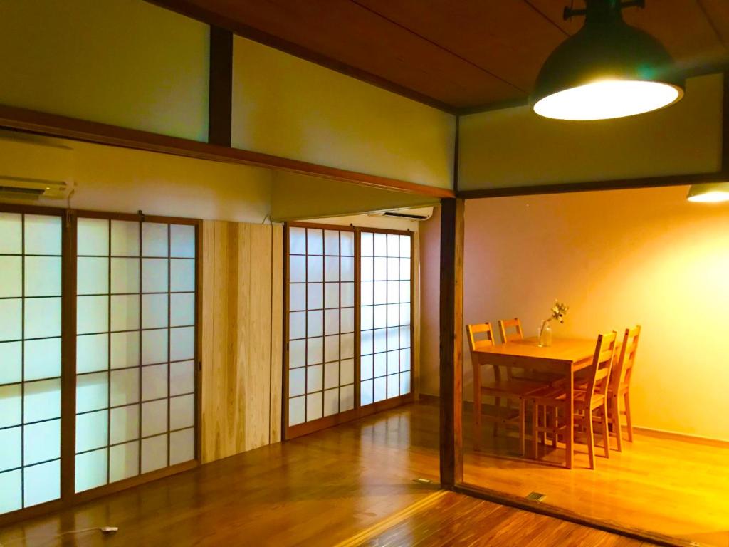 a dining room with a table and chairs at NOW TRAVEL ShinOsaka in Osaka