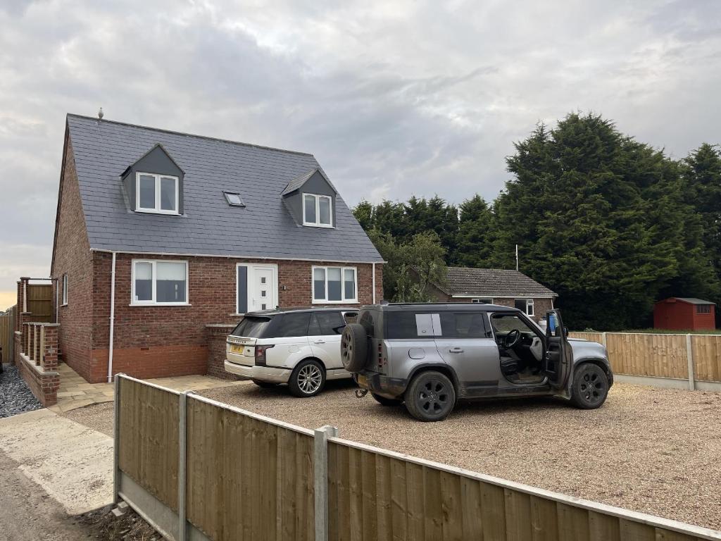 two cars parked in a driveway in front of a house at 4 bedroom House Boston Lincs Pet & Child friendly in Boston