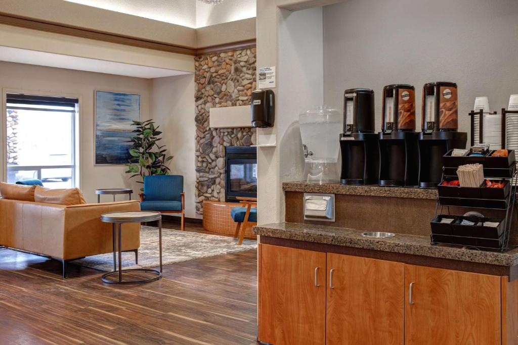 a lobby with a counter and a living room at Days Inn by Wyndham Medicine Hat in Medicine Hat