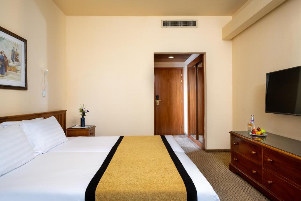 Postel nebo postele na pokoji v ubytování Olive Tree Hotel