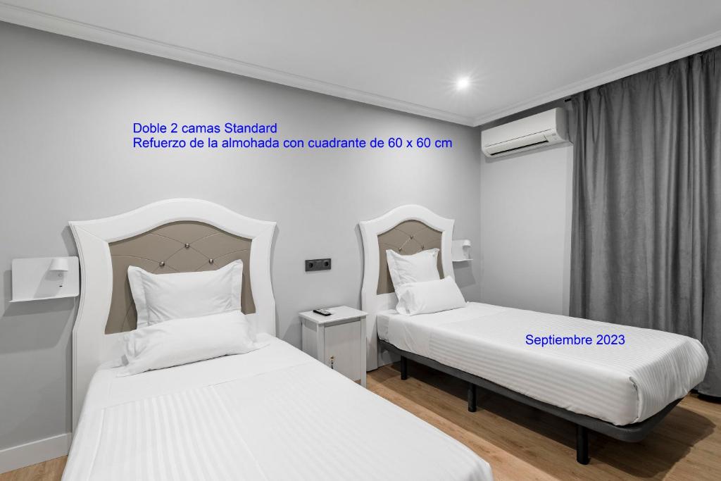 Postel nebo postele na pokoji v ubytování Hostal Los Ángeles