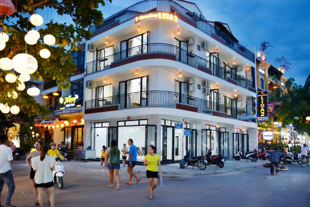 a group of people walking in front of a building at Lisa homestay 2 in Hoi An