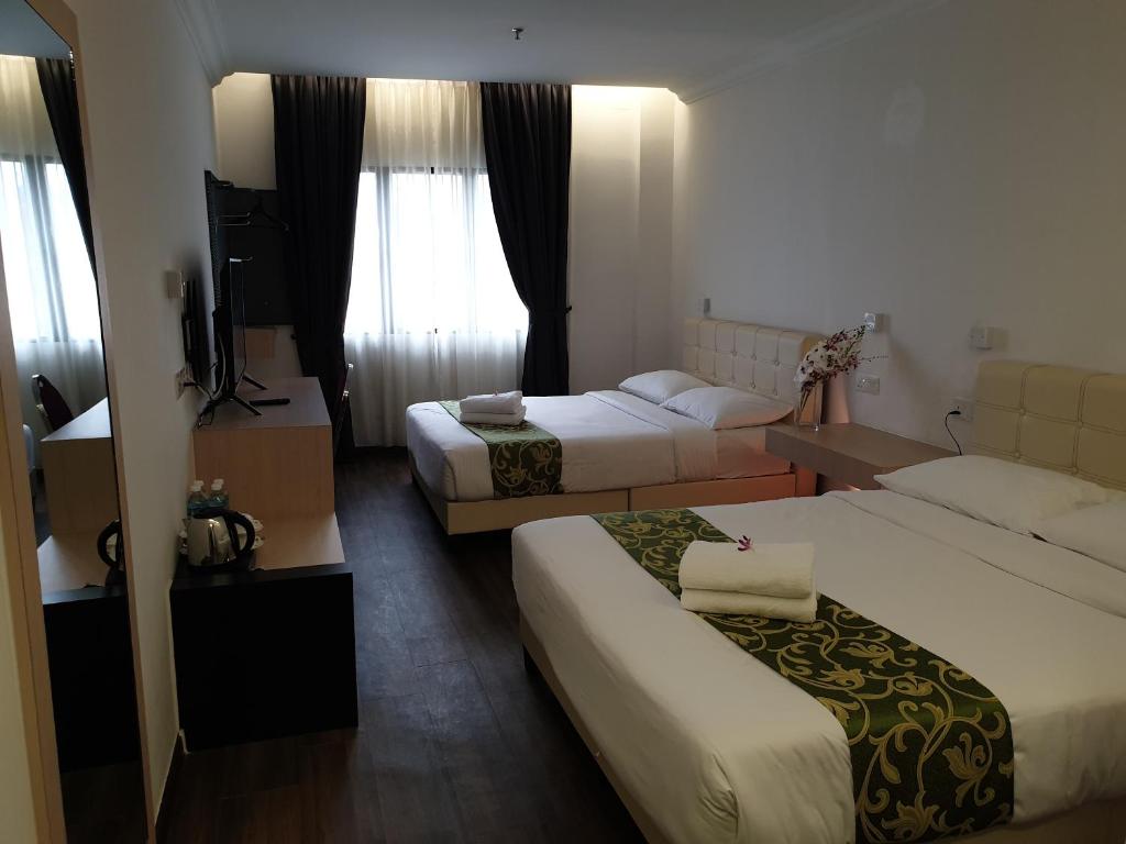 Postel nebo postele na pokoji v ubytování Fair Park Hotel