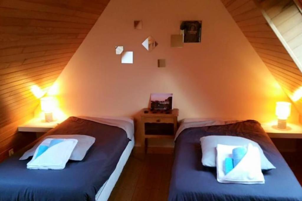 トレガステルにあるCoeur de Granitのベッドルーム(ベッド2台付)が備わる屋根裏部屋です。