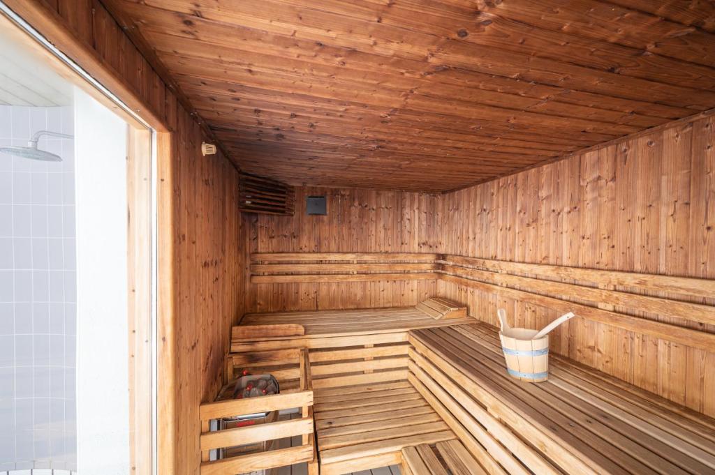 a wooden sauna with a dog sitting in it at Camping Les Vosges du Nord in Oberbronn