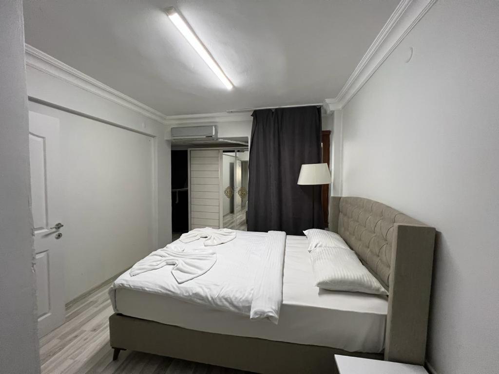 a bedroom with a bed in a white room at Taksim Beyoğlu Talimhane apart in Istanbul