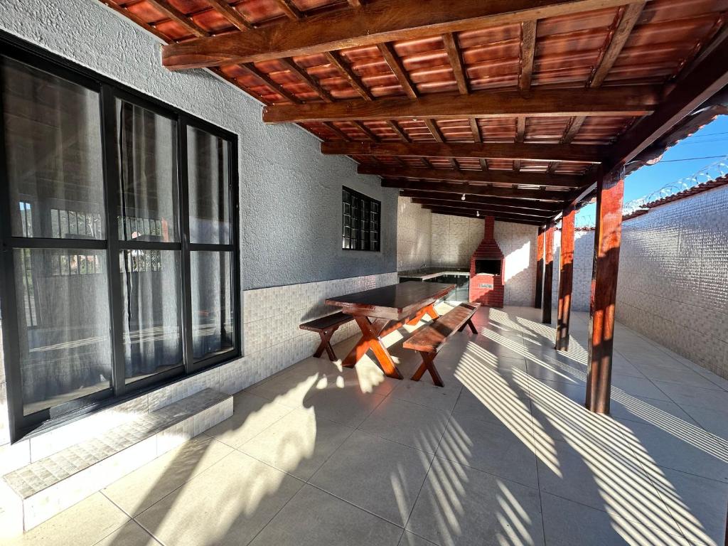 a porch with benches and windows on a building at Casa Chapadeira in Colinas Do Sul