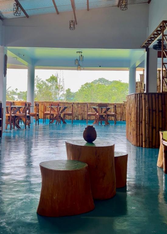 a room with wooden tables and benches in it at Bhūma in Havelock Island