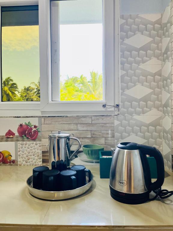 a kitchen counter with a tea pot and a kettle at Bhūma in Havelock Island