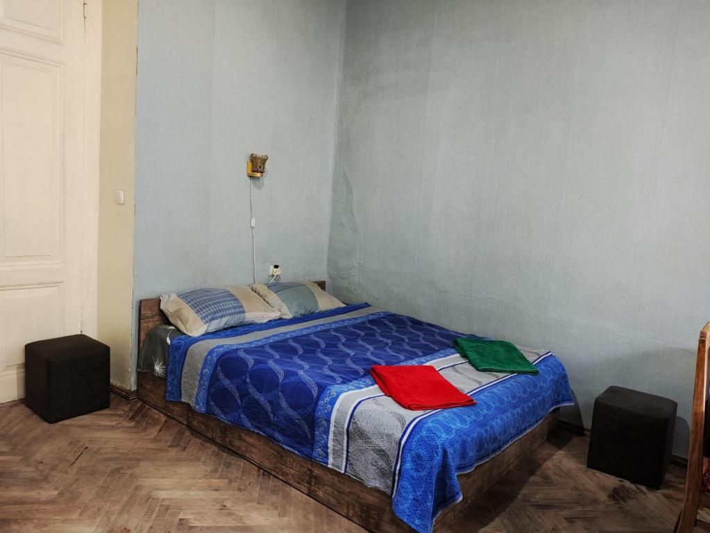 a bedroom with a blue bed with two towels on it at Jessi on Marjanishvili in Tbilisi City