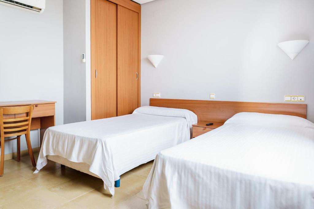 Postel nebo postele na pokoji v ubytování AS Chucena